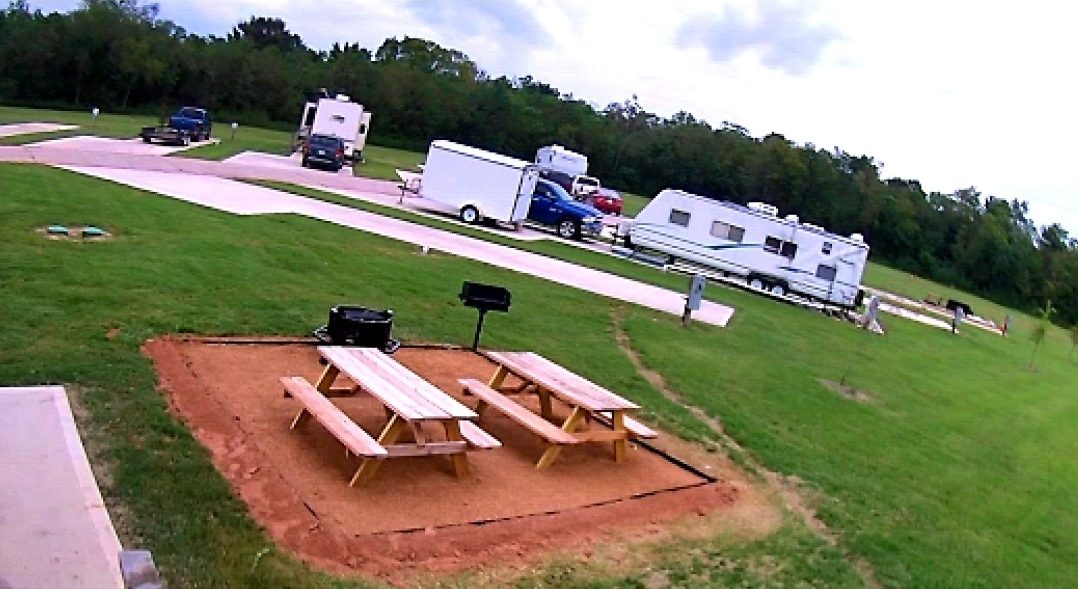 Picnic tables and grills beside RV sites at Liverpool RV Park